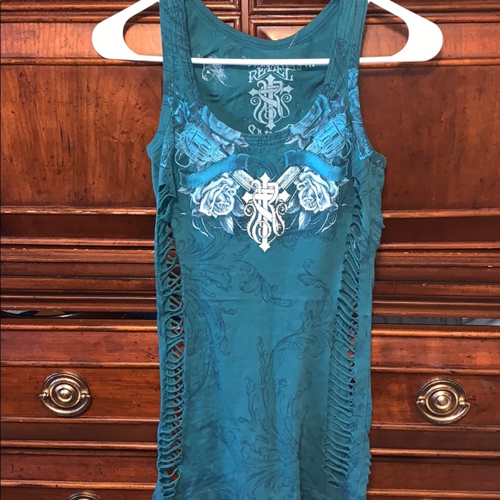 Tunic tank shredded on sides.